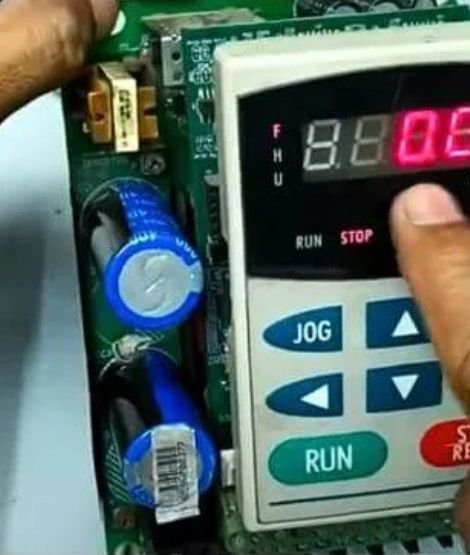A technician testing a repaired servo drive